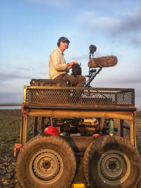 Sebastian recording ambisonic sound on top of a car in Gorongosa National Park in Mozambique